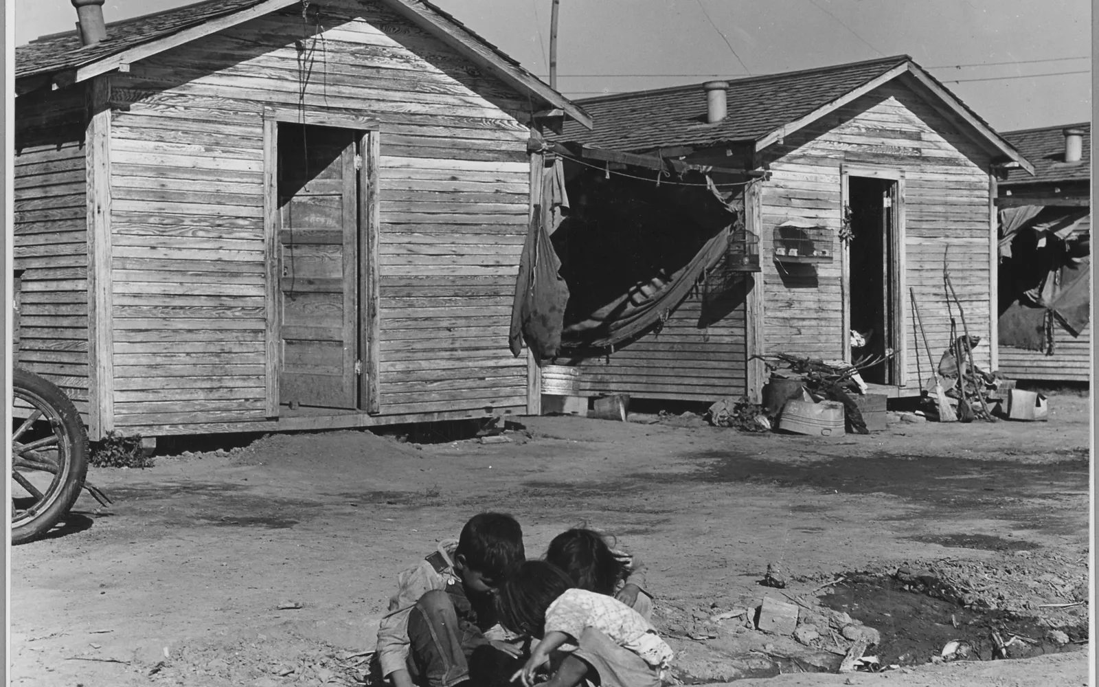 Historic 1940 photograph by Dorothea Lange showing residential structures and community housing in the San Joaquin Valley, built to house agricultural workers.